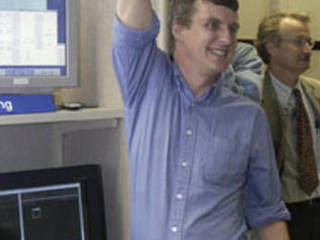 Dr. Steve Squyres, principal investigator for the science instruments 									on both Mars Exploration Rovers, celebrates as the team witnesses the 									first images sent back from Spirit.