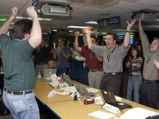 Members of the Mars Exploration Rover Mission's Entry, Descent and 									Landing team rejoice at the news that mission control received its first 									signal from Spirit, indicating the rover's safe arrival at Gusev Crater 									on Mars.