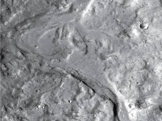 Streamlined forms in this Martian valley resulted from the outflow of a lake hundreds of millions years more recently than an era of Martian lakes previously confirmed. This image from the Context Camera on NASA's Mars Reconnaissance Orbiter covers an area in Arabia Terra about 8 miles wide.