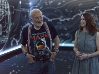 Apollo 11 astronaut Buzz Aldrin, left, and Erisa Hines of NASA's Jet Propulsion Laboratory in Pasadena, California, speak to members of the news media during a preview of the new "Destination: Mars" experience at the Kennedy Space Center visitor complex in Florida.