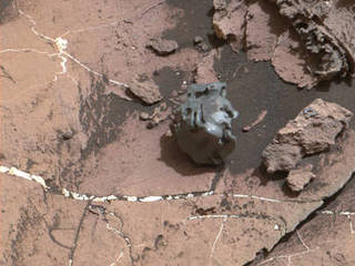 The dark, smooth-surfaced rock at the center of this Oct. 30, 2016, image from the Mast Camera (Mastcam) on NASA's Curiosity Mars rover was examined with laser pulses and confirmed to be an iron-nickel meteorite.  It is about the size of a golf ball.