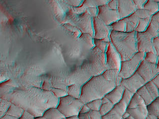 This stereo view shows an area on Mars where narrow rock ridges intersect at angles forming corners of polygons. It combines two observations from the HiRISE camera on NASA's Mars Reconnaissance Orbiter and appears three-dimensional when viewed through red-blue glasses with the red lens on the left.