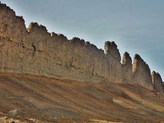This photograph from Shiprock in northwestern New Mexico shows a ridge roughly 30 feet (about 10 meters) tall that formed from lava filling an underground fracture then resisting erosion better than the material around it did.