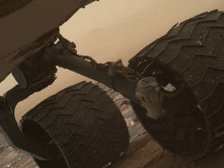 Two of the raised treads, called grousers, on the left middle wheel of NASA's Curiosity Mars rover broke during the first quarter of 2017, including the one seen partially detached at the top of the wheel in this image from the Mars Hand Lens Imager (MAHLI) camera on the rover's arm.