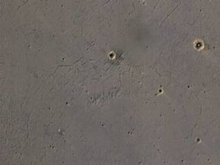 The bright landing platform left behind by NASA's Mars Exploration Rover Opportunity in 2004 is visible inside Eagle Crater, at upper right in this April 8, 2017, observation by NASA's Mars Reconnaissance Orbiter.