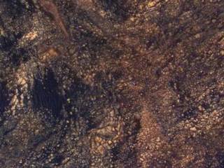 The feature that appears bright blue at the center of this scene is NASA's Curiosity Mars rover on the northwestern flank of Mount Sharp, viewed by NASA's Mars Reconnaissance Orbiter. Curiosity is approximately 10 feet long and 9 feet wide (3.0 meters by 2.8 meters).