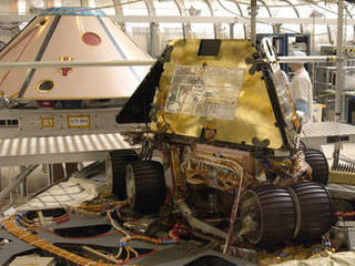 Rover 1 sits atop the deployed lander with its solar arrays and wheels stowed.