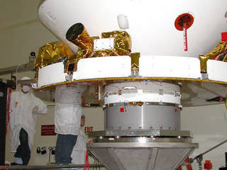 In this photo, engineers are preparing the rover for vibration testing to ensure that it can undergo the rigors of launch and entry into the martian atmosphere. The rovers are scheduled to launch next spring and will arrive at Mars in January 2004.
