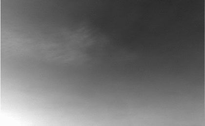 NASA's Mars Exploration Rover Opportunity captured a view of wispy afternoon clouds, not unlike fair weather clouds on Earth, passing overhead on the rover's 956th sol, or Martian day (Oct. 2, 2006).