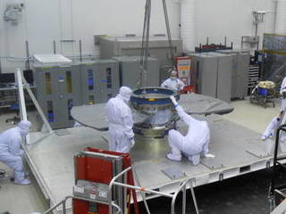 Lockheed Martin spacecraft specialists check the cruise stage of NASA's InSight spacecraft in this June 22, 2017, photo. The cruise stage will provide vital functions during the flight from Earth to Mars, and then will be jettisoned before the rest of the spacecraft enters Mars' atmosphere.